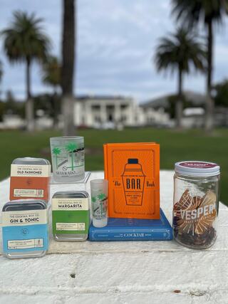 collection of cocktail kits and bar books