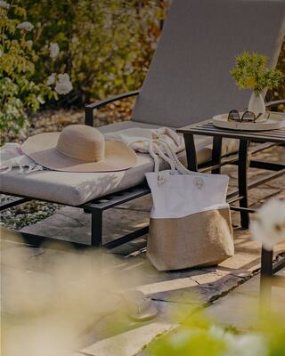 Outdoor Pool Lounge Chair with a Hat, Pool Bag, and Sunglasses