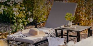 Outdoor Pool Lounge Chair with a Hat, Pool Bag, and Sunglasses