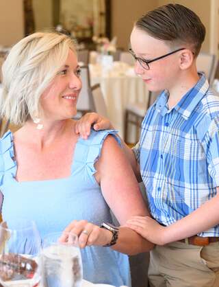 Mother and her young son sharing a special moment together at a restaurant