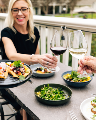 Wine and food at lunch with a woman outdoors