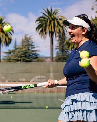 Woman Bouncing a tennis ball at Silverado Resort