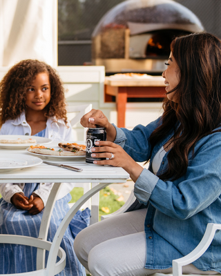 Family of four enjoying themself dining at an outdoor patio