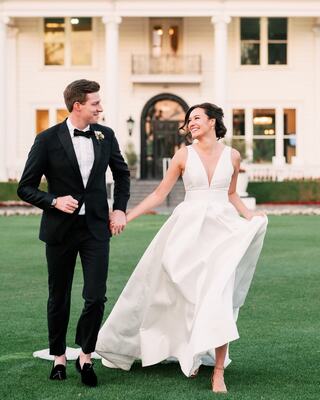 Bride and Groom walking in front of the Silverado Mansion