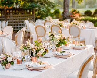 Table set up with chairs outdoors for a fancy wedding