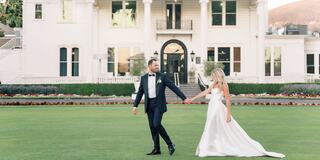Bride and groom on Silverado mansion lawn in Napa