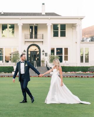 Bride and groom on Silverado mansion lawn in Napa