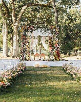 Indian wedding ceremony set up outdoors in nature among oak trees in Napa Valley