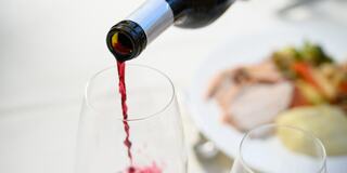 wine bottle being poured into wine glass