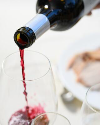wine bottle being poured into wine glass