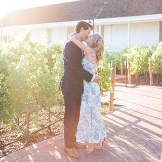 bride and groom embrace near Mansion Garden grapevines
