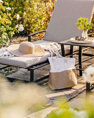 Outdoor Pool Lounge Chair with a Hat, Pool Bag, and Sunglasses
