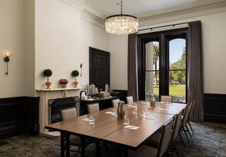 Meeting room in a resort in Napa Valley set up for a boardroom meeting with a table and chairs