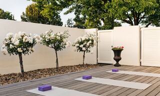 Yoga Mats Outside on a Patio with Flowering Rose Trees