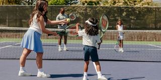 family playing tennis on the silverado courts