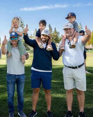 Three Male Fans with Children Giving a Thumbs Up on a Golf Course at the Napa PGA Golf Championship