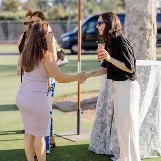 two women networking at a group event