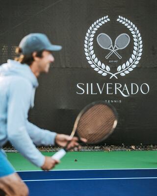A Man in a Baseball Cap Playing Tennis on the Tennis Court at Silverado Resort in Napa