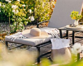 Outdoor Pool Lounge Chair with a Hat, Pool Bag, and Sunglasses