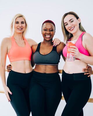 three women posing in fitness gear