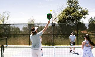 Male instructor teaching pickleball