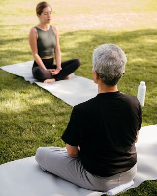 practicing yoga in group fitness class