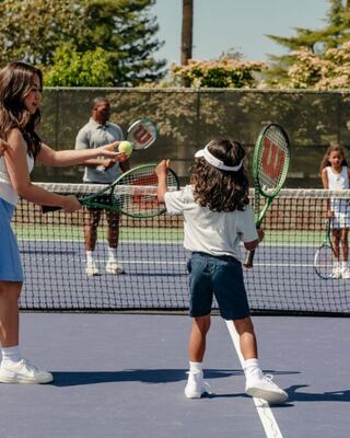 A family playing Tennis at Silverado Resort