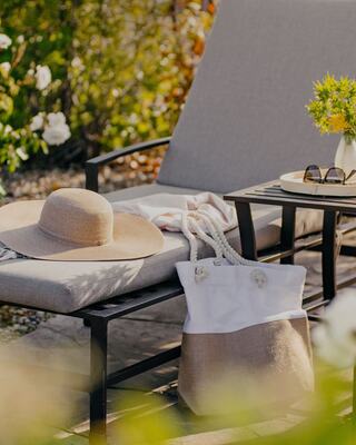Outdoor Pool Lounge Chair with a Hat, Pool Bag, and Sunglasses