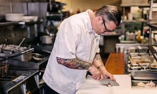Executive Chef Preparing Ingredients with a Knife in a Commercial Kitchen in Napa