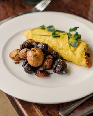 Plated Breakfast Egg and Potatoes Entrée at a Napa Restaurant on a Table
