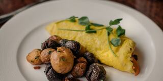 Plated Breakfast Egg and Potatoes Entrée at a Napa Restaurant on a Table