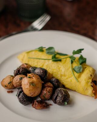 Plated Breakfast Egg and Potatoes Entrée at a Napa Restaurant on a Table