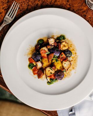 Seasonal Plated Entrée with Silverware on a Table
