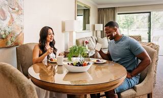 Couple Enjoying In Room Dining at a Table Inside a Hotel Suite in Napa
