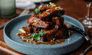 Plated Microgreens Salad at a Napa Restaurant on a Table with Glasses of Wine and Water