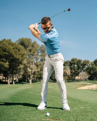 Male Golfer Taking a Swing at a Ball on the Golf Course in Napa