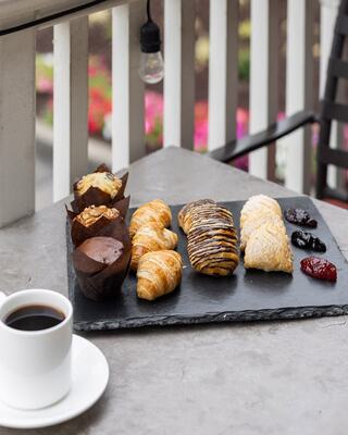 Baked Pastries with a Cup of Coffee on a Table on an Outdoor Patio