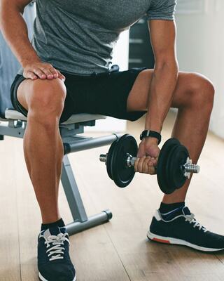 A Man Lifting a Free Weight Inside a Fitness Studio at a Napa Valley Resort