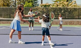 Family with Two Kids Playing Tennis Together