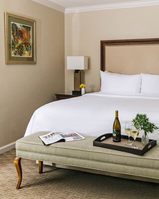 Hotel Room with a Bed, Furniture and a bottle of wine in Napa Valley