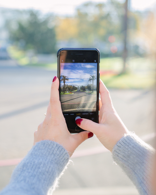 Two Hands Holding up a Phone Camera with a View of The Mansion at Silverado Resort in Napa