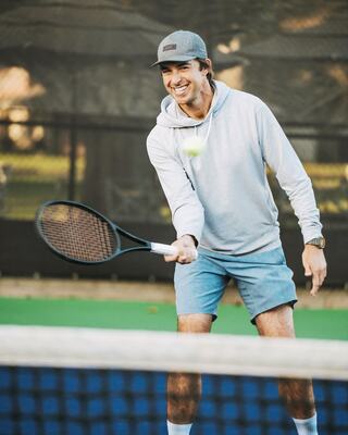 Male Tennis Player on Tennis Court Aiming to Hit the Ball with his Racquet