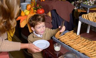 Little boy at a buffet for Thanksgiving with his mother
