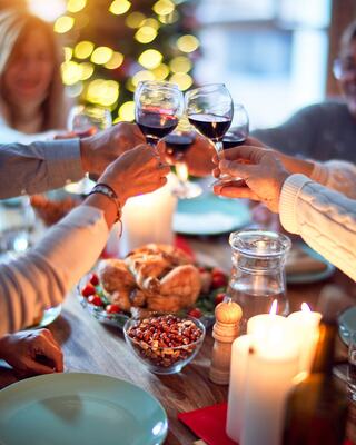 group of dinner guests cheers